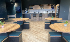 Morph round cafe tables and stools are finished with reclaimed scaffold boards