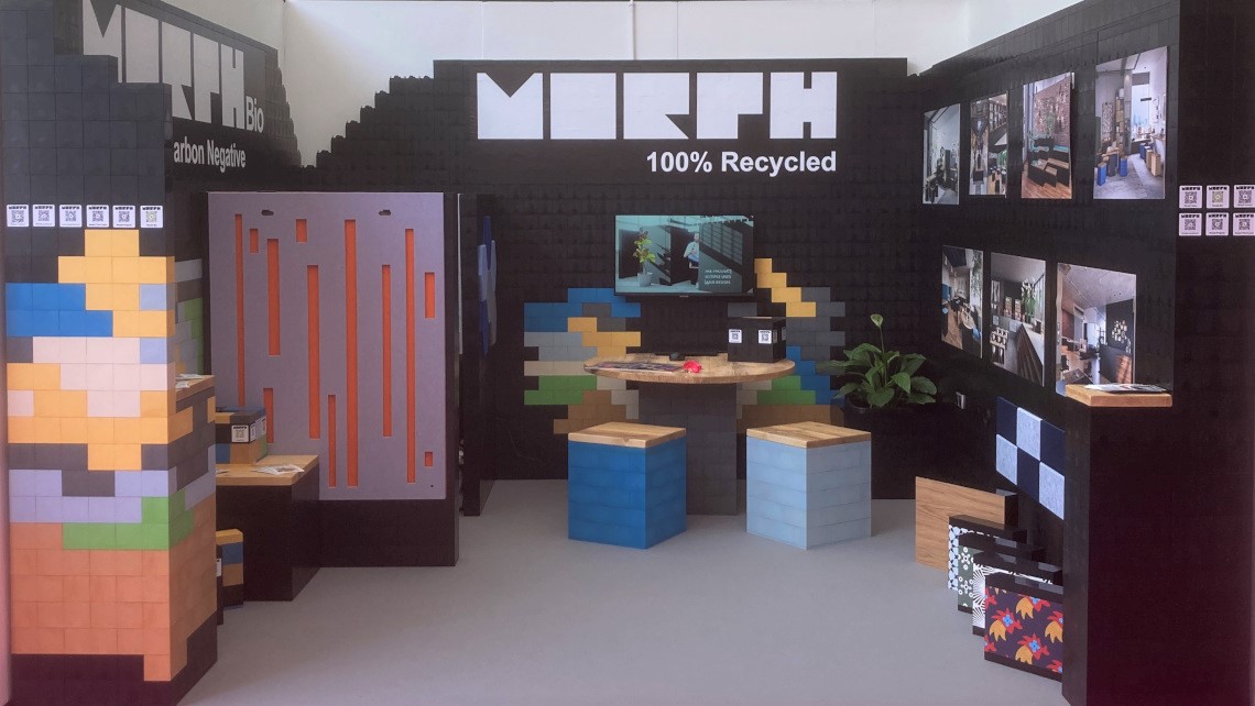 Stand at event showcasing Morph and Morph Bio with walls, stools, table, plinths, Morph Calling